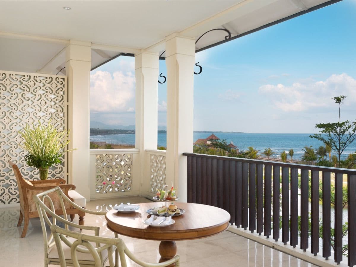 The luxury suite, with a seating area and balcony doors.